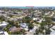 Aerial view of the property, surrounded by mature trees, and Gulf Of America in the background at 417 Park Lane Dr, Venice, FL 34285