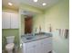 Bathroom features a single sink vanity, updated lighting, and lots of storage at 417 Park Lane Dr, Venice, FL 34285