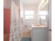 Cozy bathroom with vanity, peach-colored bathtub, and tiled floor at 417 Park Lane Dr, Venice, FL 34285