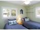 Bedroom featuring two twin beds, ceiling fan, and shuttered windows at 417 Park Lane Dr, Venice, FL 34285