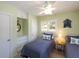 Bedroom with neutral color, ceiling fan, and shuttered windows at 417 Park Lane Dr, Venice, FL 34285