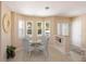 Bright breakfast nook with multiple windows providing natural light, stylish decor, and seamless access to the entrance at 417 Park Lane Dr, Venice, FL 34285