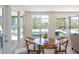 Bright breakfast nook with wooden table and views of the pool area through large windows at 417 Park Lane Dr, Venice, FL 34285