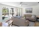 Bright and cozy Florida room with serene pool views through the many windows and a ceiling fan for year-round comfort at 417 Park Lane Dr, Venice, FL 34285