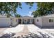 Attractive single-story home featuring a symmetrical design, a front porch, and manicured landscaping at 417 Park Lane Dr, Venice, FL 34285