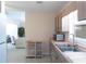 View of the kitchen with stainless steel sink and microwave, leading into the living room at 417 Park Lane Dr, Venice, FL 34285