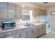 Efficient kitchen with stainless steel microwave and a double basin sink under a window at 417 Park Lane Dr, Venice, FL 34285