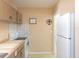 Kitchen featuring white appliances, white backsplash and beige cabinetry at 417 Park Lane Dr, Venice, FL 34285