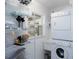 Organized laundry room with washer, dryer, shelving and small window at 417 Park Lane Dr, Venice, FL 34285