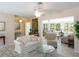 Spacious living room seamlessly connects to a bright sunroom and breakfast nook, perfect for relaxing and entertaining at 417 Park Lane Dr, Venice, FL 34285