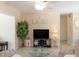 Cozy living room features a ceiling fan, neutral walls, tile floors, and a large entertainment center at 417 Park Lane Dr, Venice, FL 34285