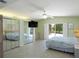 Bright main bedroom featuring tile floors, ceiling fan, and sliding glass doors to the outdoor area at 417 Park Lane Dr, Venice, FL 34285