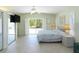 Airy main bedroom featuring sliding door access to the lanai and tiled floors at 417 Park Lane Dr, Venice, FL 34285