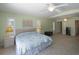 Bright main bedroom featuring tile floors, ceiling fan, and neutral paint color at 417 Park Lane Dr, Venice, FL 34285