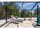 Relaxing poolside lounge area inside screened enclosure, providing a private outdoor oasis at 417 Park Lane Dr, Venice, FL 34285