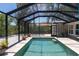 Screened pool enclosure, offering a refreshing escape with tropical views at 417 Park Lane Dr, Venice, FL 34285