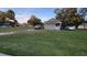 Charming home with green siding, a screened porch, and a large lawn at 4223 Sawyer Rd, Sarasota, FL 34233