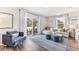 Inviting living room features a plush sofa, blue accent chair, and sliding glass doors leading to a patio at 4326 Miller Point Ct, Bradenton, FL 34208