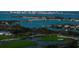 Scenic aerial view showcasing waterfront homes, a golf course, and bridges against a city skyline at 435 L Ambiance Dr # Ph-J, Longboat Key, FL 34228