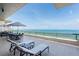 Spacious outdoor patio with chairs overlooking the ocean at 435 L Ambiance Dr # Ph-J, Longboat Key, FL 34228
