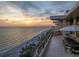 Spacious balcony with seating area overlooking a beautiful beach and ocean at sunset at 435 L Ambiance Dr # Ph-J, Longboat Key, FL 34228