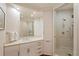 Bathroom featuring a large mirror, vanity with cabinet storage, and shower at 435 L Ambiance Dr # Ph-J, Longboat Key, FL 34228