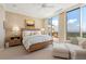 The bedroom features a view, access to the balcony and plenty of natural light at 435 L Ambiance Dr # Ph-J, Longboat Key, FL 34228