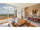 Bright dining room featuring floor-to-ceiling windows with views, access to the balcony, and an open-plan living area at 435 L Ambiance Dr # Ph-J, Longboat Key, FL 34228