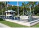 Elegant entrance to L'Ambiance featuring a water fountain, lush greenery, and a guard house at 435 L Ambiance Dr # Ph-J, Longboat Key, FL 34228