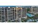 Luxury high-rise building featuring private balconies and a pool overlooking the ocean and cityscape at 435 L Ambiance Dr # Ph-J, Longboat Key, FL 34228