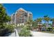 Elegant beachfront condo with multiple balconies surrounded by lush greenery and palm trees at 435 L Ambiance Dr # Ph-J, Longboat Key, FL 34228