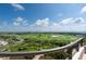 Scenic view of a lush green golf course and stunning ocean views from the property's elevated vantage point at 435 L Ambiance Dr # Ph-J, Longboat Key, FL 34228
