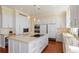 Spacious kitchen features wooden floors, a large island, and modern, stainless steel appliances at 435 L Ambiance Dr # Ph-J, Longboat Key, FL 34228
