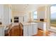 Modern kitchen with white cabinetry, center island, and views of the golf course and ocean at 435 L Ambiance Dr # Ph-J, Longboat Key, FL 34228
