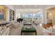 Spacious living room boasting a piano, built-in bookshelves, and stunning ocean views through large windows at 435 L Ambiance Dr # Ph-J, Longboat Key, FL 34228