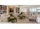 Elegant living room with grand piano, bookshelves, and floor to ceiling windows overlooking the water at 435 L Ambiance Dr # Ph-J, Longboat Key, FL 34228