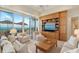 Relaxing living room featuring built-in entertainment center with panoramic ocean views at 435 L Ambiance Dr # Ph-J, Longboat Key, FL 34228