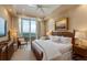 Bright main bedroom with balcony, art and ample natural light featuring a king bed and two side tables at 435 L Ambiance Dr # Ph-J, Longboat Key, FL 34228