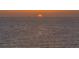 Tranquil ocean view at sunset, featuring a calm sea and a glimpse of the setting sun at 435 L Ambiance Dr # Ph-J, Longboat Key, FL 34228