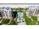Aerial view of a sparkling blue pool surrounded by palm trees and luxury condominium buildings at 435 L Ambiance Dr # Ph-J, Longboat Key, FL 34228