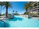 Inviting pool with waterfall feature, lounge seating, and tropical landscaping at 435 L Ambiance Dr # Ph-J, Longboat Key, FL 34228