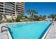 Expansive outdoor pool area with lounge seating and lush tropical landscaping at 435 L Ambiance Dr # Ph-J, Longboat Key, FL 34228