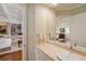 The powder room features a unique sink, wallpapered walls and is located next to the living area at 435 L Ambiance Dr # Ph-J, Longboat Key, FL 34228