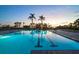 Large swimming pool with palm trees, sun loungers, and landscaping providing a relaxing atmosphere at 435 L Ambiance Dr # Ph-J, Longboat Key, FL 34228