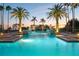 Inviting swimming pool illuminated at dusk, lined with palm trees, creating a resort-like ambiance at 435 L Ambiance Dr # Ph-J, Longboat Key, FL 34228