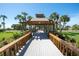 Picturesque wooden walkway with covered gazebo leading towards the beach at 435 L Ambiance Dr # Ph-J, Longboat Key, FL 34228