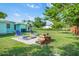 The private backyard retreat features a firepit, lounge chairs, lush greenery, and a freshly painted home exterior at 4519 Brooksdale Dr, Sarasota, FL 34232