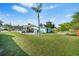 Spacious backyard with a covered boat area, mature trees, and plenty of green space for outdoor enjoyment at 4519 Brooksdale Dr, Sarasota, FL 34232