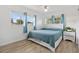 Comfortable bedroom with large windows, blue bedding, and a stylish nightstand at 4519 Brooksdale Dr, Sarasota, FL 34232