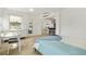 Bright bedroom space featuring a desk, storage, modern flooring, with a doorway to other living spaces at 4519 Brooksdale Dr, Sarasota, FL 34232